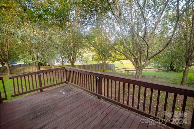 wooden deck featuring a yard