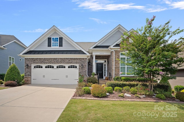 craftsman inspired home with a garage, concrete driveway, metal roof, a standing seam roof, and brick siding