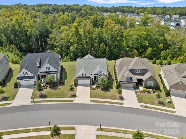 bird's eye view featuring a forest view and a residential view