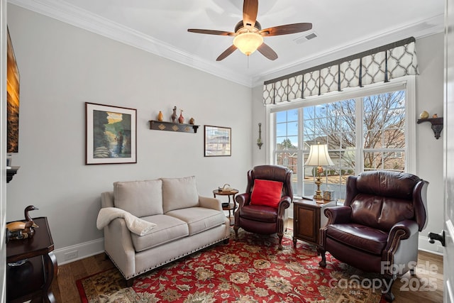 living area with ceiling fan, wood finished floors, visible vents, baseboards, and crown molding