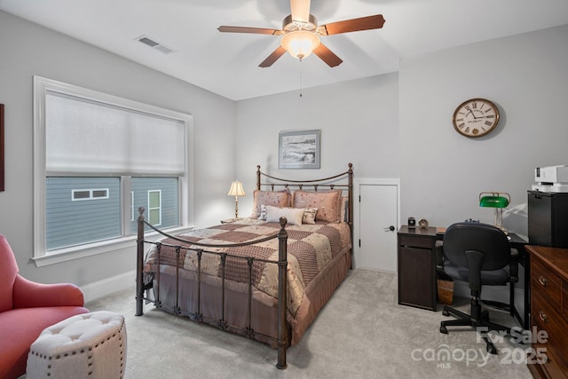 bedroom with a ceiling fan, visible vents, light carpet, and baseboards