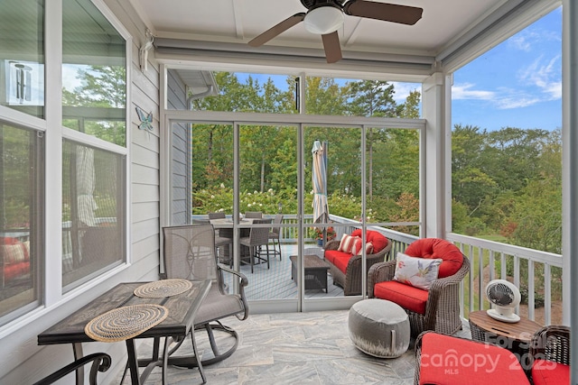 sunroom featuring ceiling fan