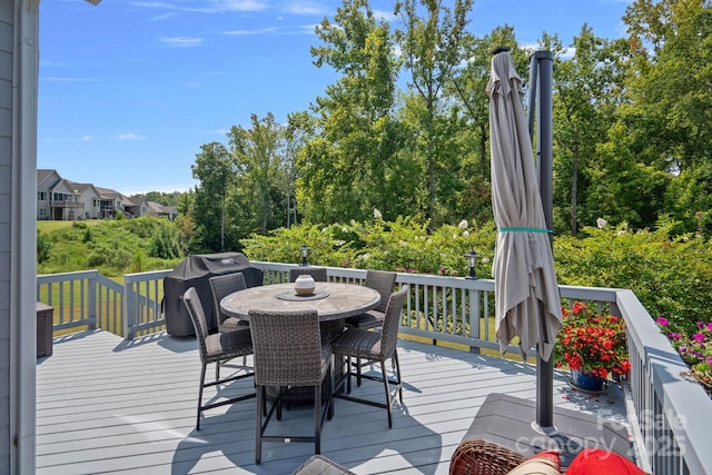 wooden deck featuring outdoor dining space and grilling area