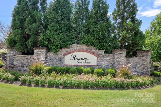 community sign featuring a lawn