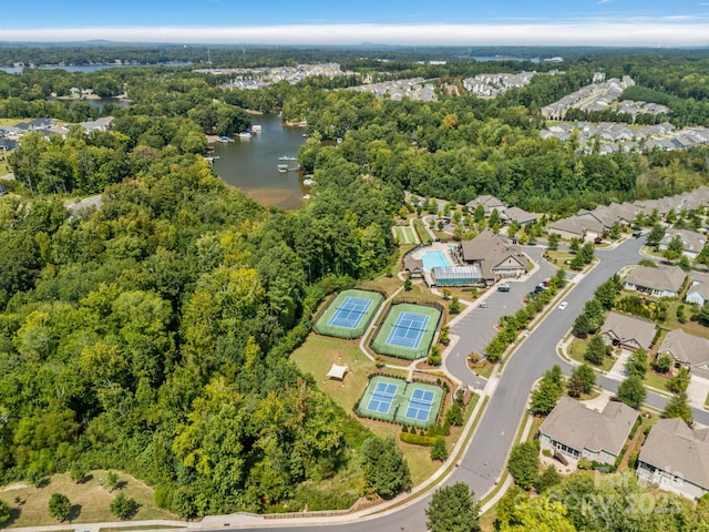 bird's eye view featuring a water view, a residential view, and a wooded view