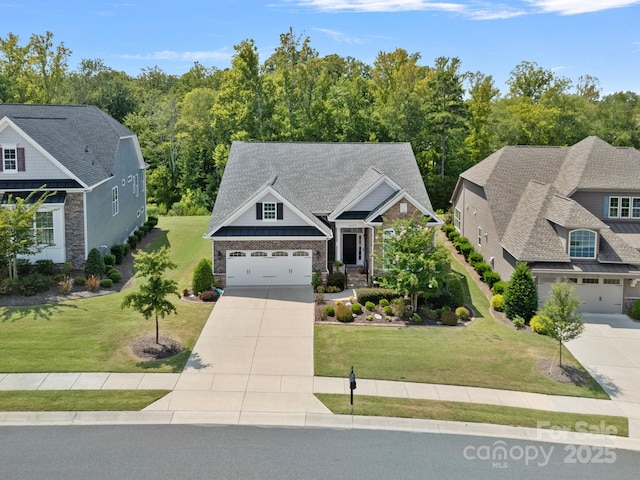 craftsman-style home with a shingled roof, a front lawn, and concrete driveway