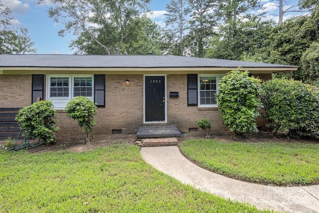 ranch-style house with crawl space, brick siding, and a front lawn