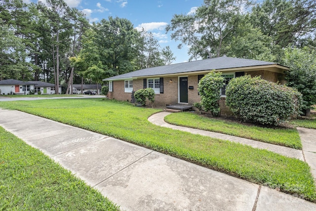 single story home with a front lawn and brick siding