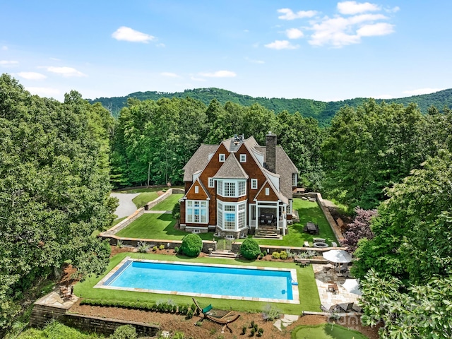 view of swimming pool with a yard and a patio