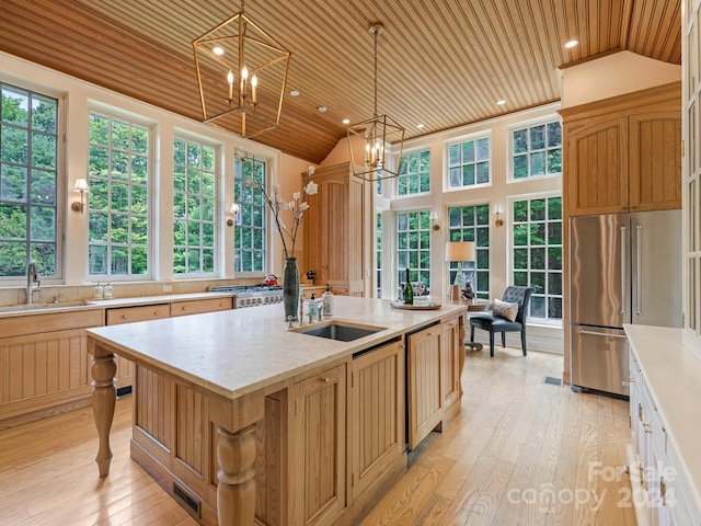 kitchen with pendant lighting, sink, a center island with sink, light hardwood / wood-style floors, and wood ceiling