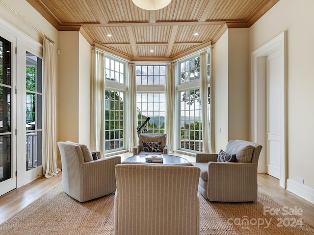 living room featuring wood ceiling, a healthy amount of sunlight, and light hardwood / wood-style floors