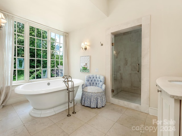 bathroom featuring a healthy amount of sunlight, tile patterned floors, and independent shower and bath