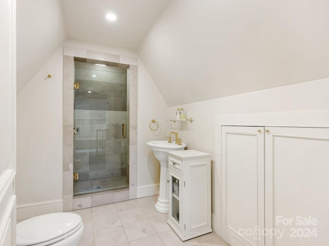 bathroom featuring tile patterned flooring, vaulted ceiling, toilet, and an enclosed shower