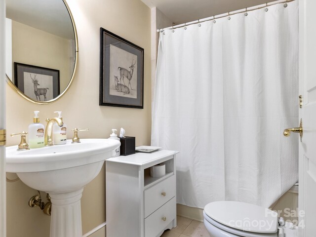 bathroom with tile patterned flooring and toilet