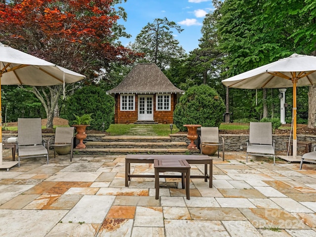 view of patio with an outbuilding