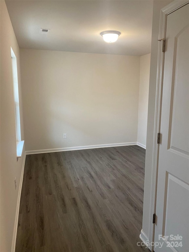 empty room with dark wood-type flooring