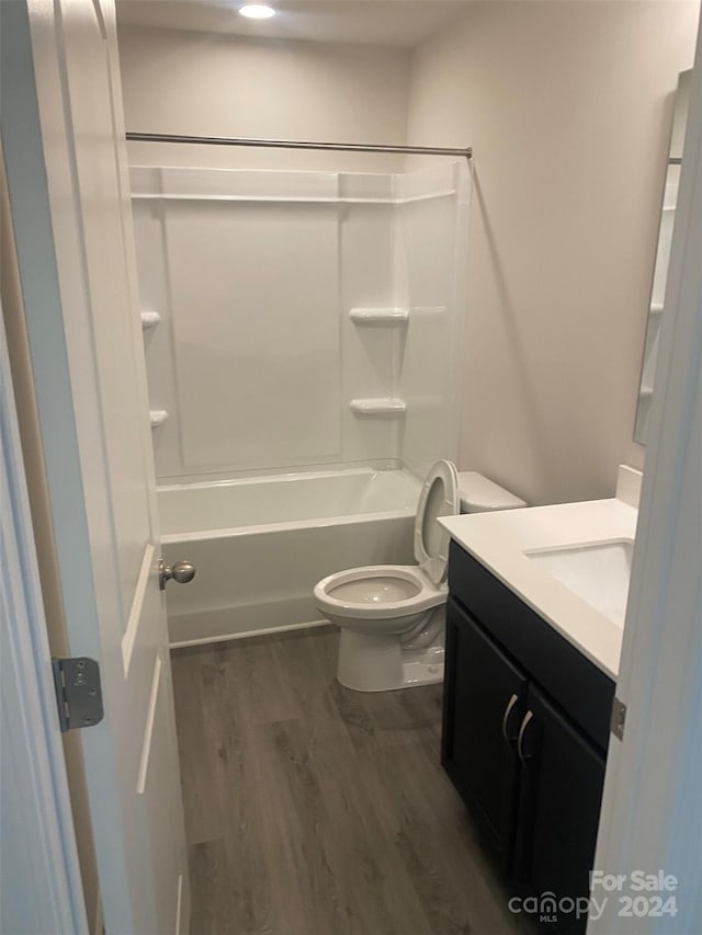 full bathroom featuring vanity, toilet, wood-type flooring, and tub / shower combination