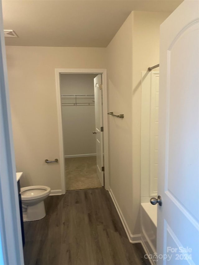 bathroom with toilet and wood-type flooring