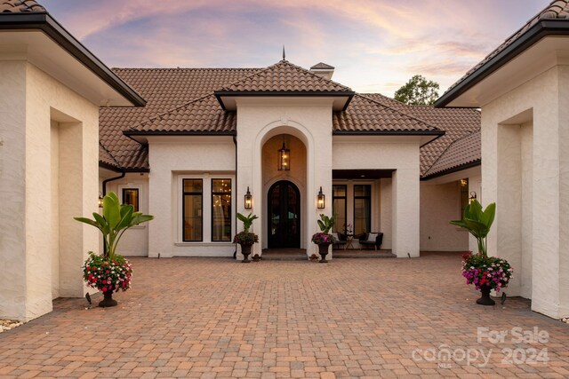 view of exterior entry at dusk