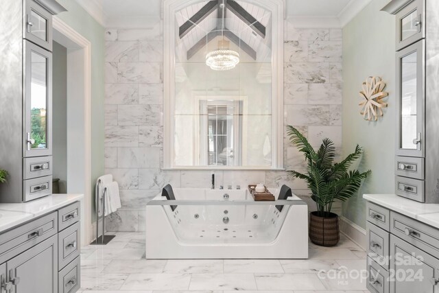 bathroom featuring tile walls, a washtub, tile patterned flooring, vanity, and ornamental molding