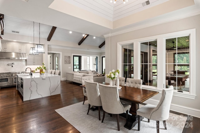 dining space featuring dark wood-type flooring and beamed ceiling