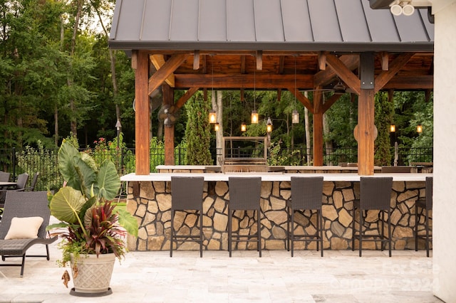 view of patio / terrace with an outdoor bar and ceiling fan