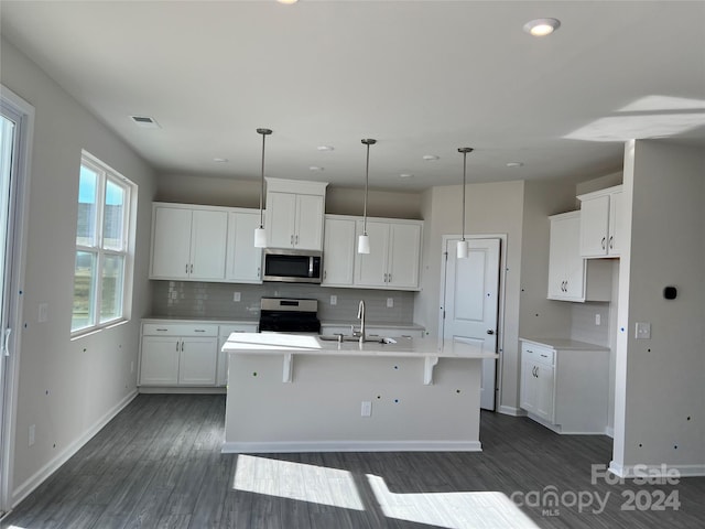 kitchen featuring range, white cabinets, a center island with sink, sink, and dark hardwood / wood-style flooring