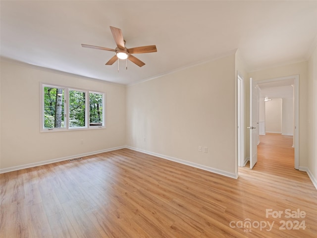 unfurnished room with crown molding, light wood-type flooring, and ceiling fan