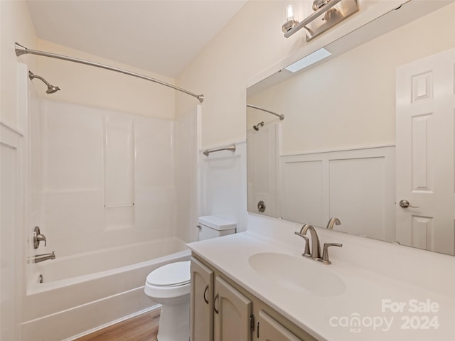 full bathroom with wood-type flooring, bathing tub / shower combination, toilet, and vanity