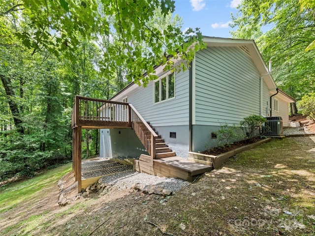 exterior space with cooling unit and a wooden deck