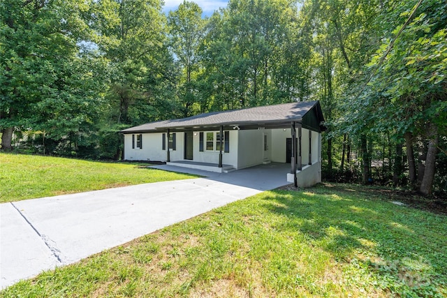 ranch-style house featuring driveway, a carport, and a front yard