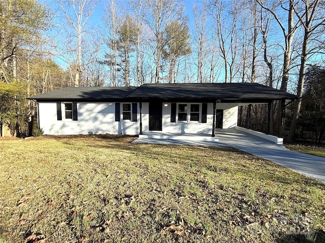 single story home with a carport, concrete driveway, and a front yard