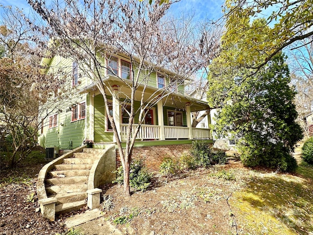 view of front of home with cooling unit and a porch