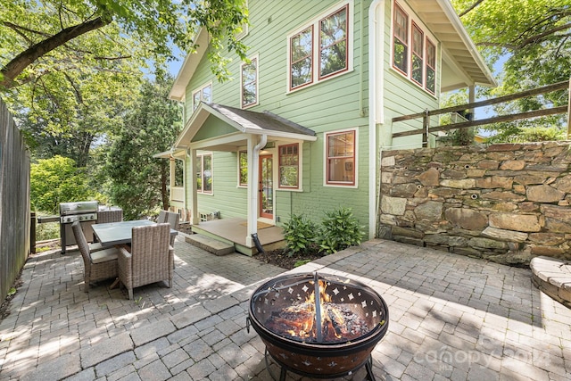 view of patio / terrace featuring area for grilling and a fire pit