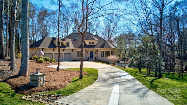 view of front facade with a garage, driveway, and a front lawn