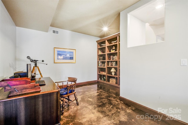 office area featuring visible vents, concrete floors, and baseboards