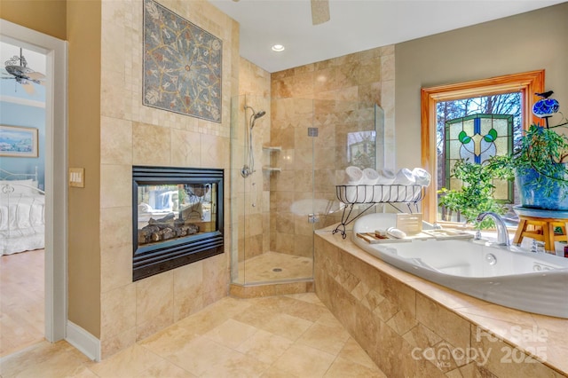 full bathroom featuring a tiled fireplace, a ceiling fan, tiled shower, ensuite bath, and a bath