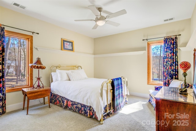 bedroom featuring carpet floors, visible vents, and baseboards