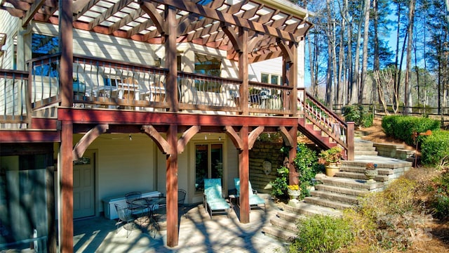 back of house featuring a wooden deck, stairway, a pergola, and a patio