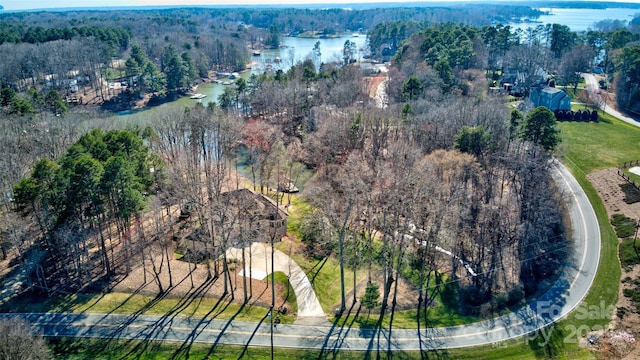 birds eye view of property featuring a water view and a forest view