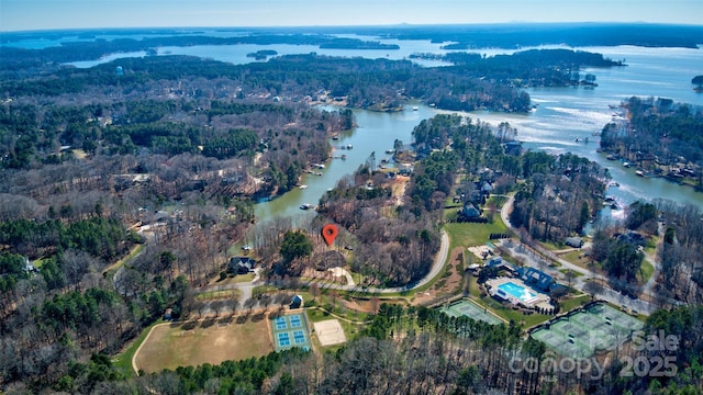 birds eye view of property with a water view and a forest view