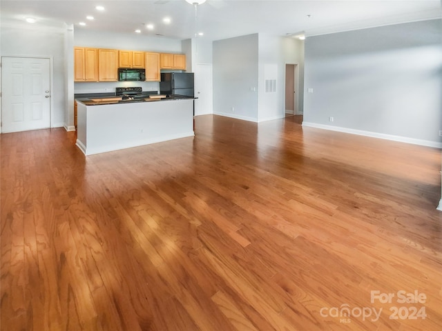 kitchen with a kitchen island, light hardwood / wood-style flooring, and black appliances