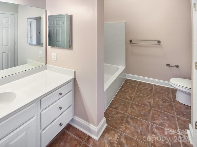 bathroom with vanity, tile patterned floors, and toilet