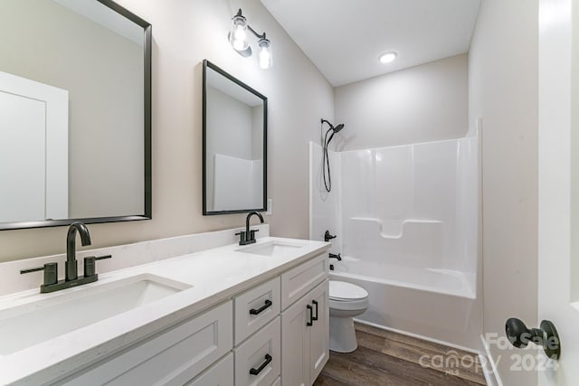 full bathroom with toilet, wood-type flooring, bathtub / shower combination, and dual bowl vanity