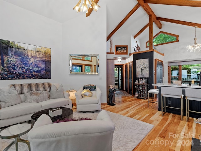 living room with beamed ceiling, light wood-type flooring, high vaulted ceiling, and a chandelier