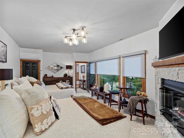 carpeted bedroom featuring a fireplace and an inviting chandelier