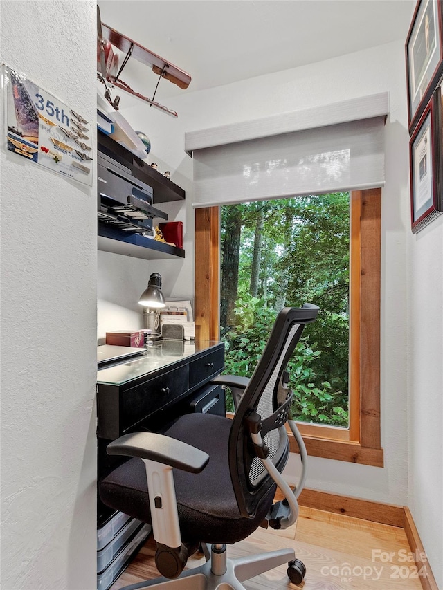 home office with baseboards and wood finished floors