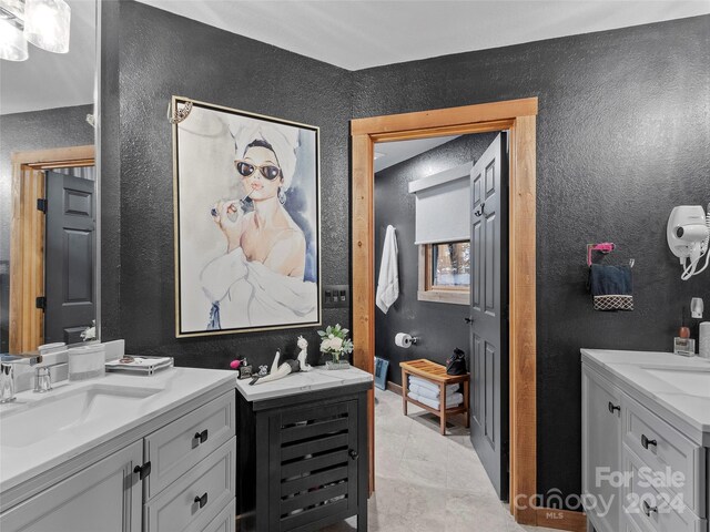 bathroom featuring dual bowl vanity and tile patterned floors