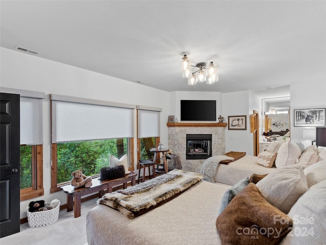 carpeted bedroom with visible vents and a fireplace