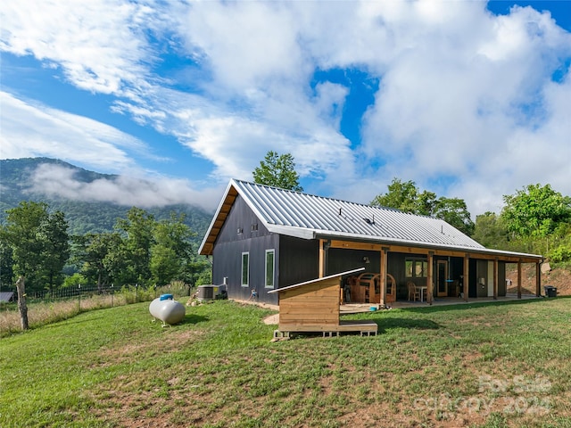 rear view of property featuring a yard